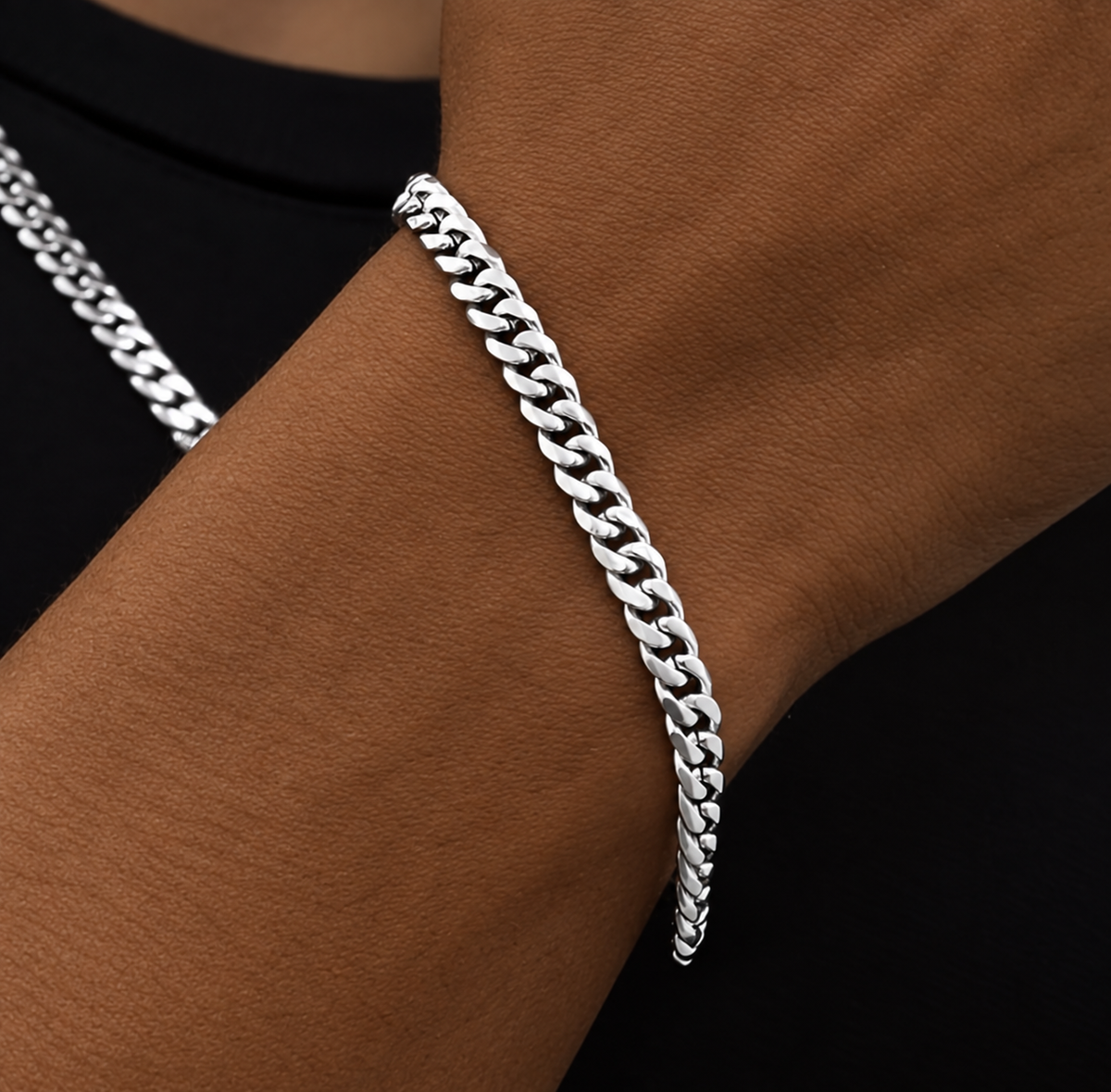 Close-up of a silver tone link bracelet worn on a wrist
