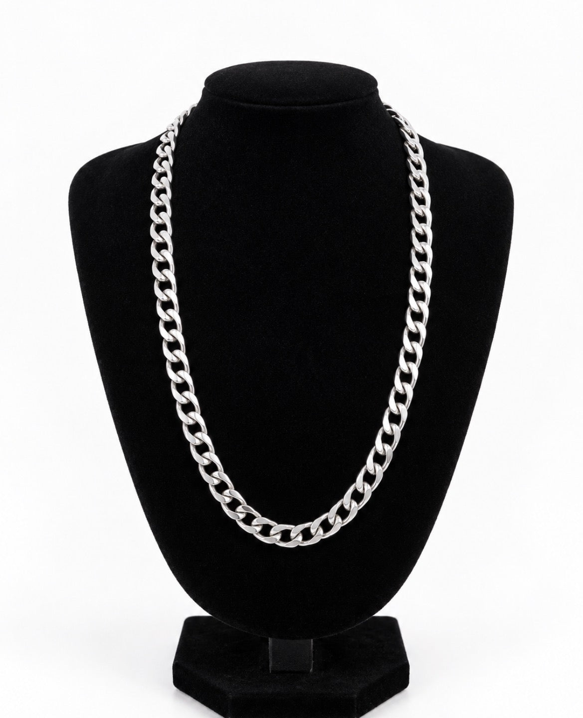 Silver tone curb chain necklace displayed on a black jewellery bust