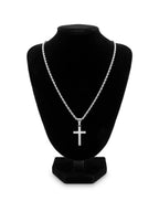 Silver tone cross pendant necklace on a black jewellery bust