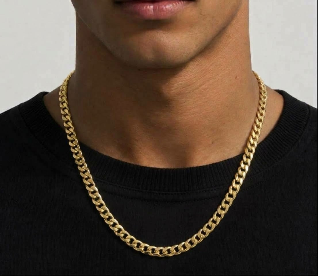 Gold tone curb chain necklace worn over a black top
