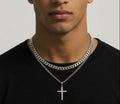 Layered silver tone curb chain and cross pendant necklace worn together