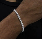 Close-up of a silver tone tennis bracelet with round clear stones