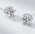 Pair of silver tone stud earrings with round clear stones