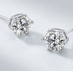 Pair of silver tone stud earrings with round clear stones