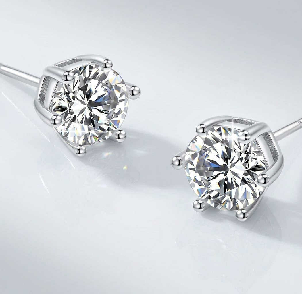 Pair of silver tone stud earrings with round clear stones