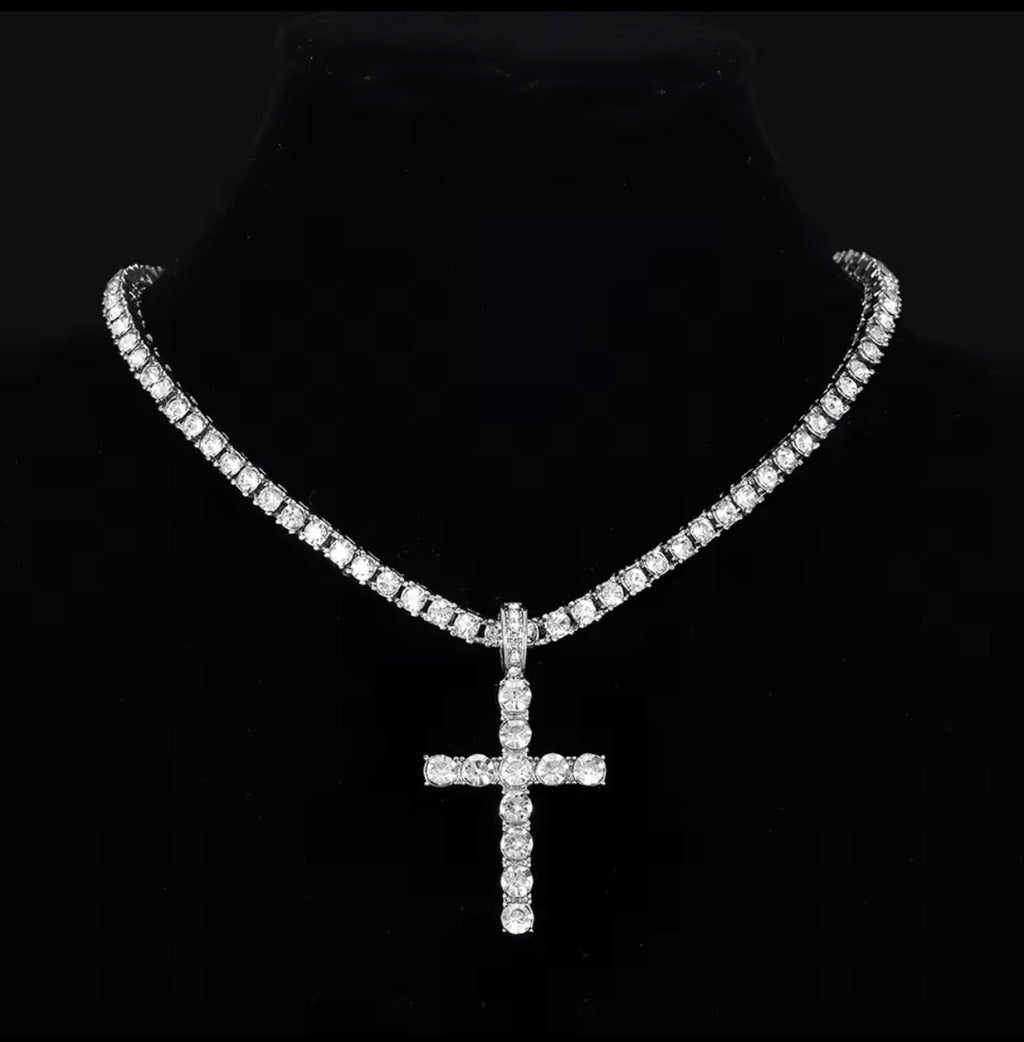 Silver tone clear-stone cross pendant necklace on a black jewellery bust