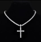 Silver tone clear-stone cross pendant necklace on a black jewellery bust