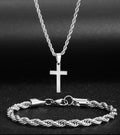 Silver tone rope chain cross necklace and bracelet on a dark background