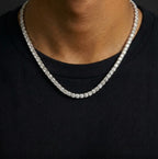 Silver tone tennis chain necklace with clear stones worn over a black top
