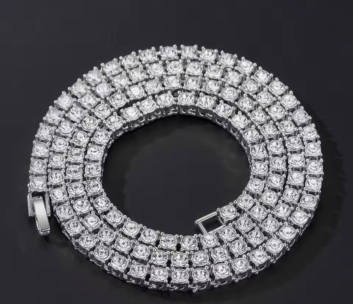 Close-up of a silver tone clear-stone tennis chain arranged in a coil