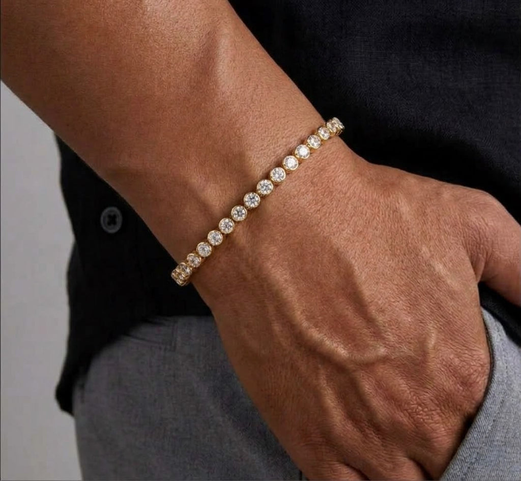 Gold tone clear-stone tennis bracelet worn on a wrist