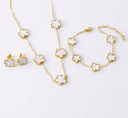 White clover necklace, bracelet and stud earrings with gold tone settings