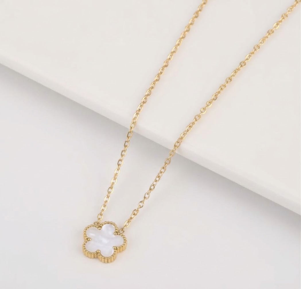 White clover pendant with beaded edging on a gold tone chain