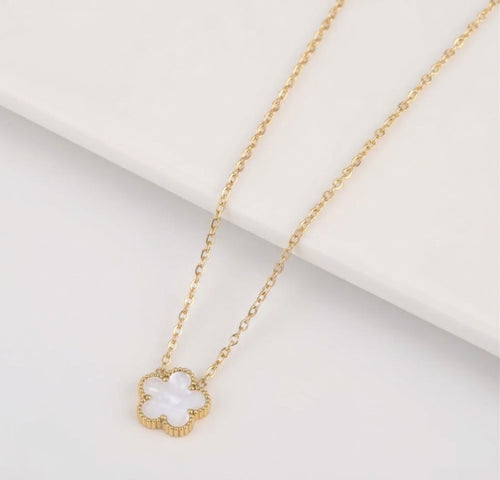 White clover pendant with beaded edging on a gold tone chain