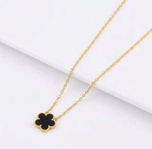 Black clover pendant with beaded edging on a gold tone chain