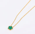 Green clover pendant with beaded edging on a gold tone chain