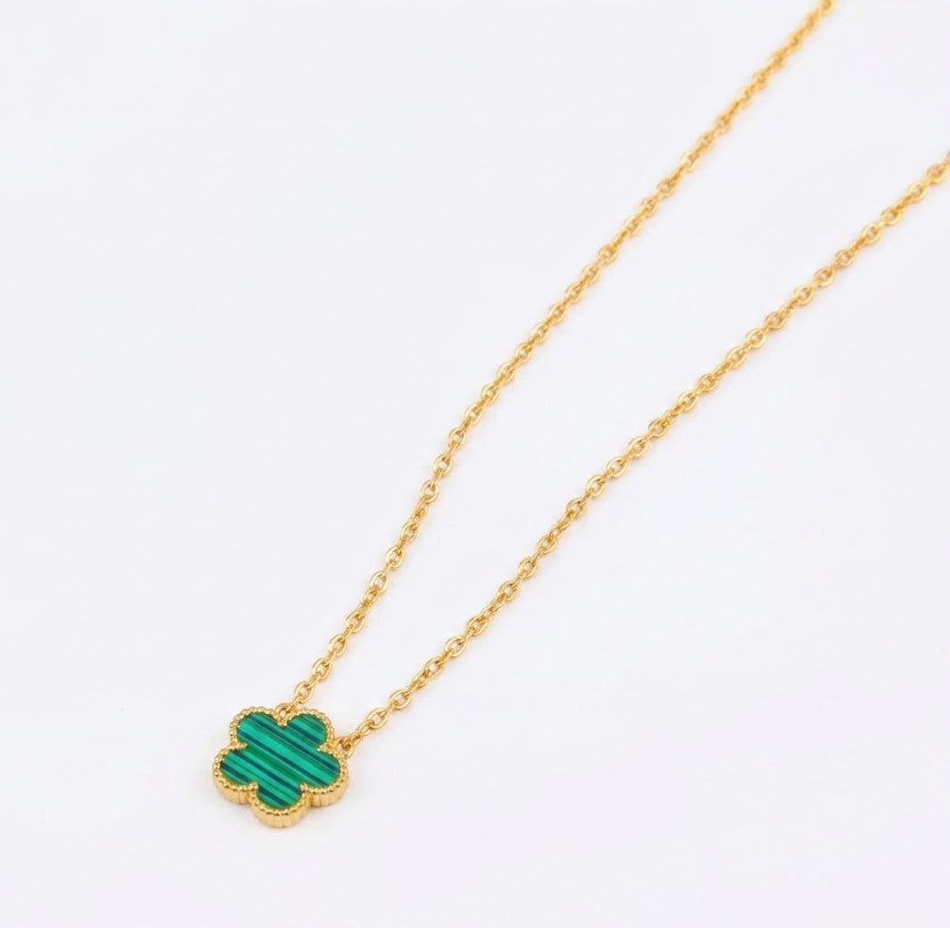 Green clover pendant with beaded edging on a gold tone chain