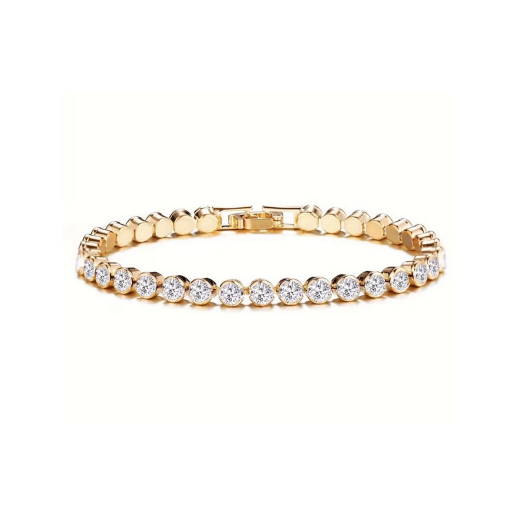Gold tone tennis bracelet with round clear stones on a white background