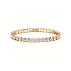 Gold tone tennis bracelet with round clear stones on a white background