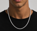 Silver tone rope chain necklace worn over a black top