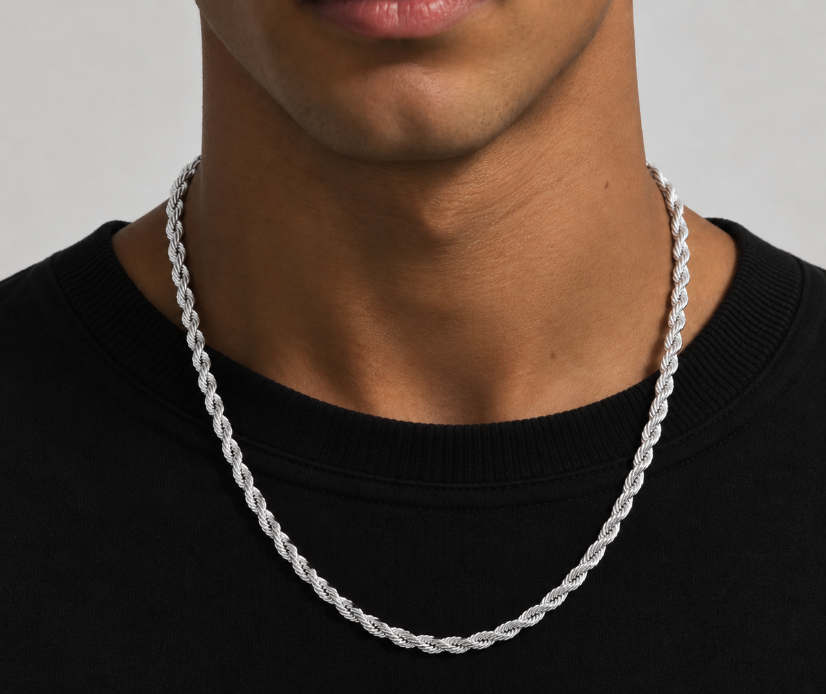 Silver tone rope chain necklace worn over a black top