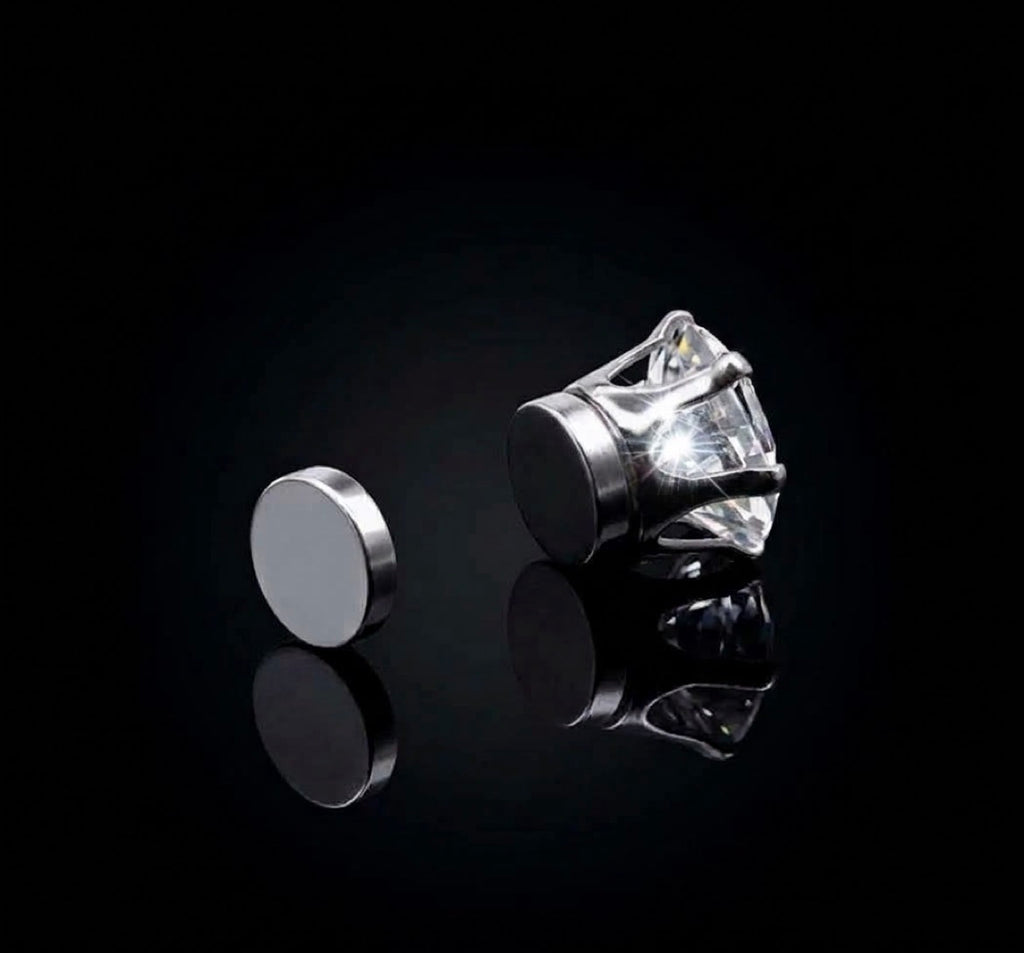 Silver tone magnetic earring shown beside its round magnetic backing
