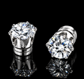 Pair of silver tone magnetic earrings with round clear stones