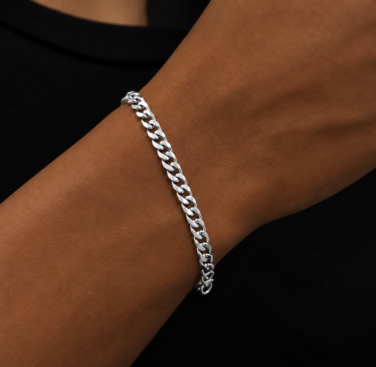Polished silver tone link bracelet worn on a wrist