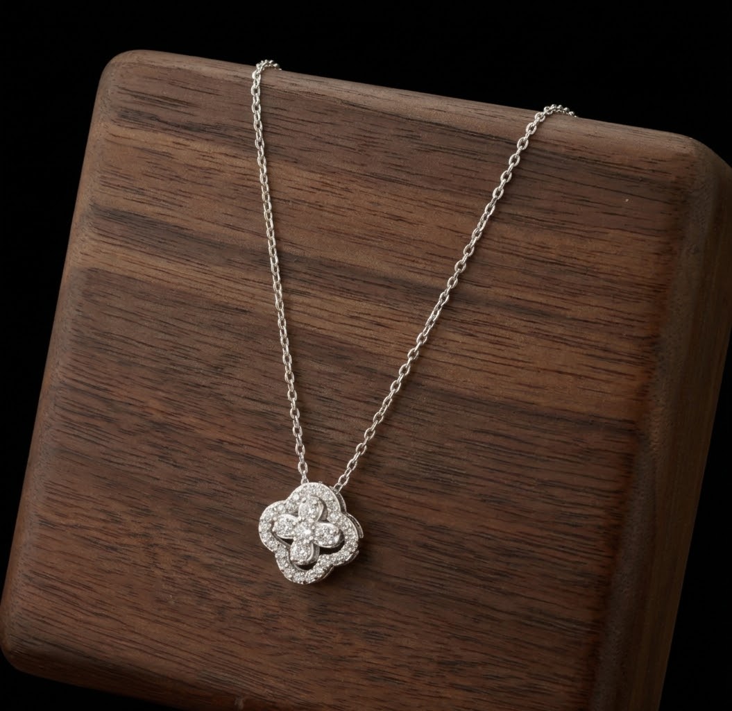 Silver tone sparkling clover pendant necklace displayed on wood