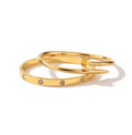 Gold tone nail-inspired bangle and stone-detail bangle on a white background
